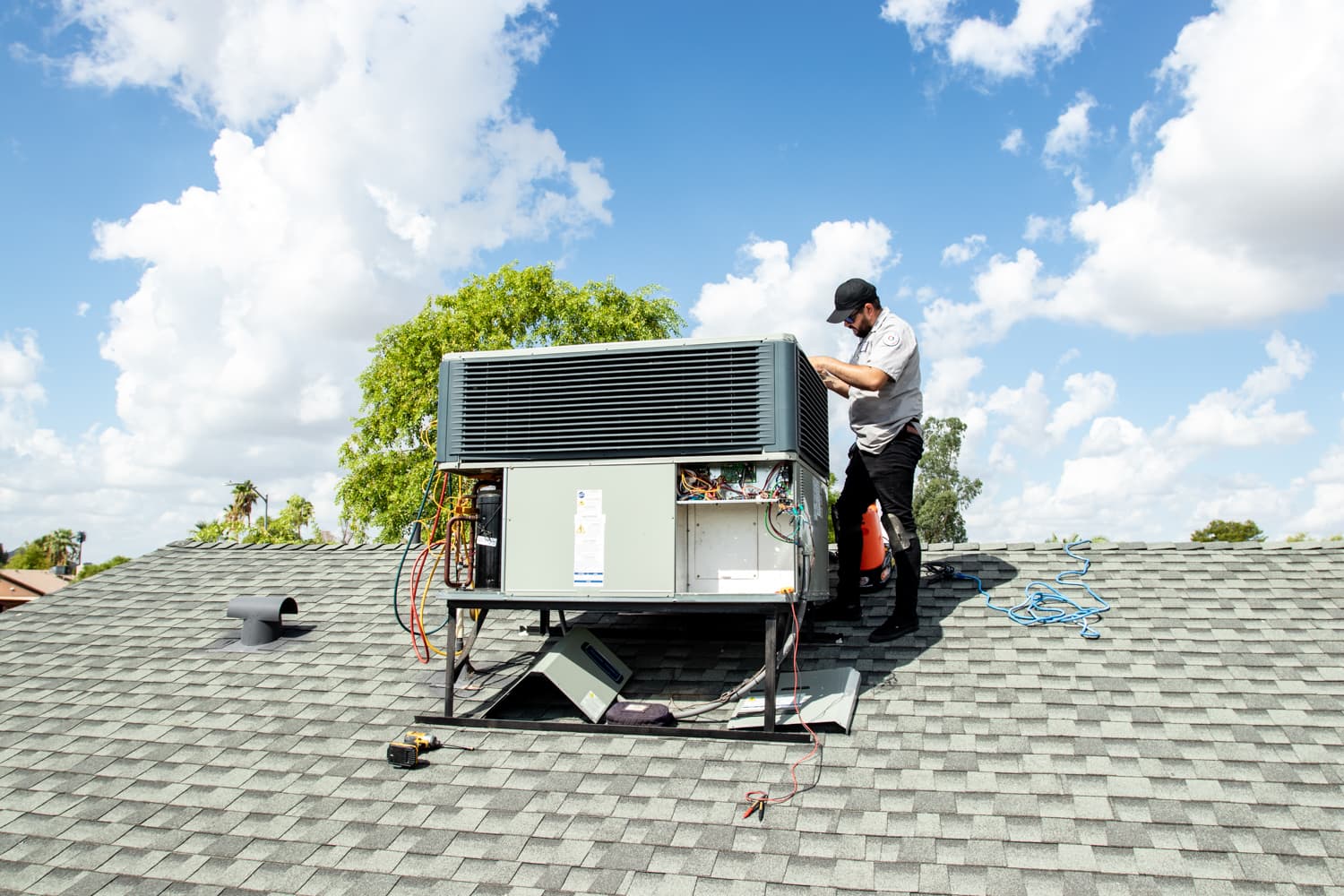 NVM technician servicing an outdoor HVAC unit